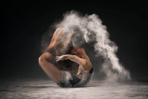 Dancer caught in a fluid spinning motion in the studio.