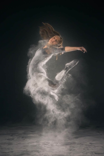 High-energy leap captured in a dramatic studio lighting setup.