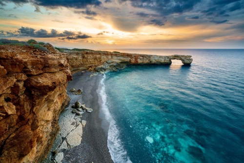 rock formation of kamara beach at sunset