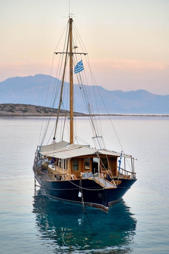 vintage greek boat at dawn