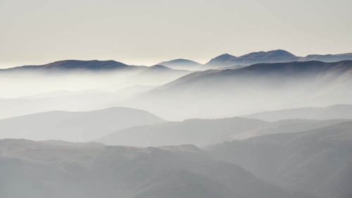 layesr of romanian mountains at dusk