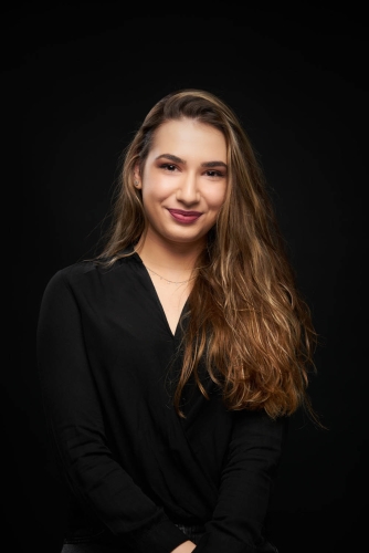 Smiling woman captured in a well-lit studio portrait session