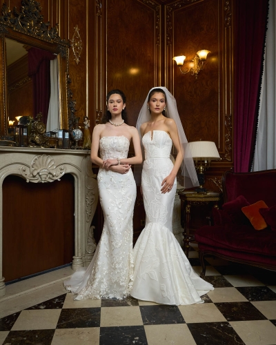 Two models in elegant wedding dresses posing in a grand palace in Bucharest.